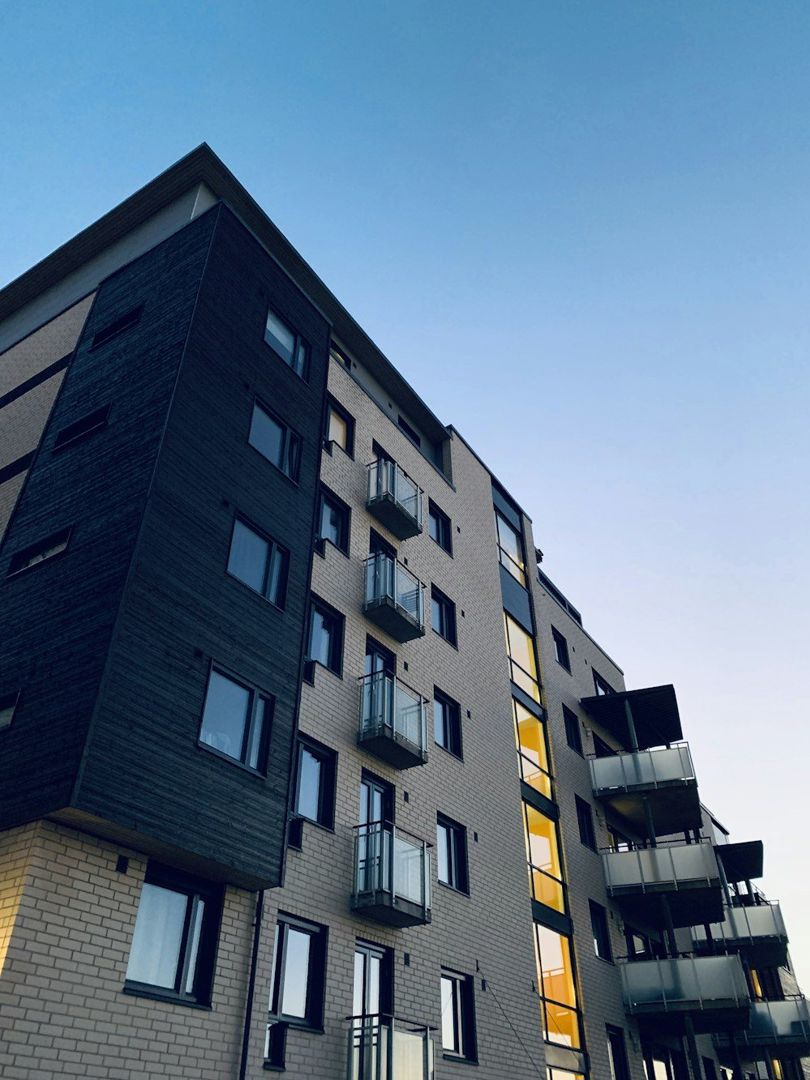 Dark brick apartment block with recessed balconies