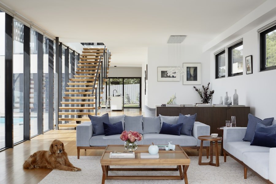 Bright double-height living room with an open timber stair