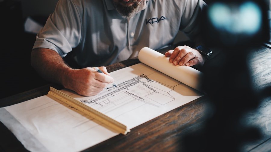 Architect marking up drawings beside a rolled plan